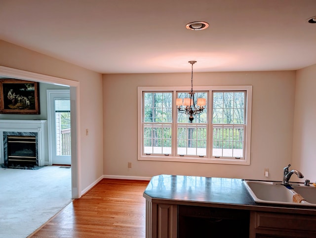 kitchen featuring dishwashing machine, hanging light fixtures, a healthy amount of sunlight, and sink