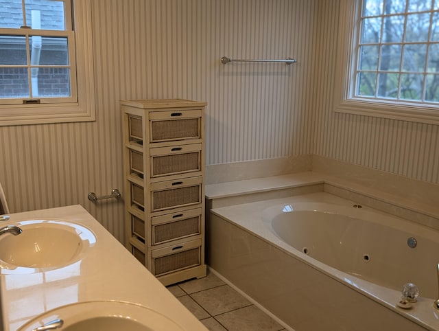 bathroom with tile patterned floors, a bathtub, and vanity