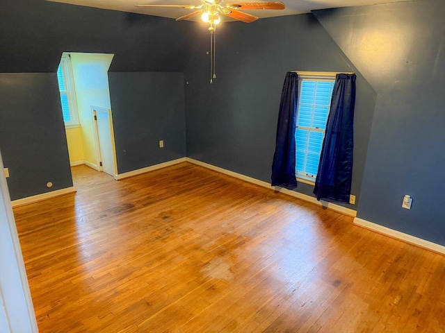 additional living space featuring light hardwood / wood-style flooring, ceiling fan, and lofted ceiling