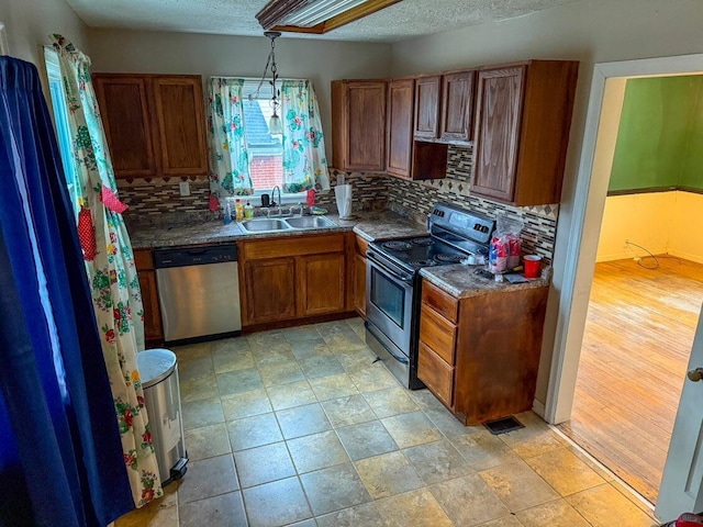 kitchen with sink, tasteful backsplash, stainless steel dishwasher, black / electric stove, and light hardwood / wood-style floors