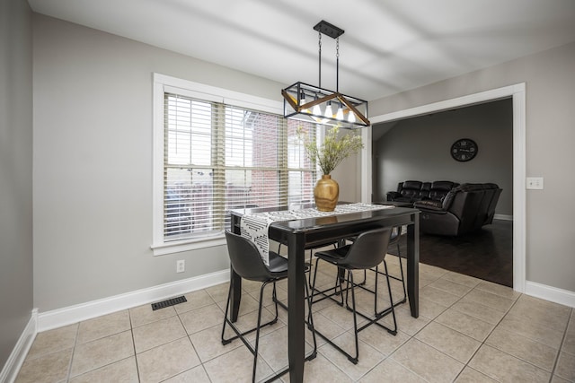 dining space featuring light tile patterned flooring