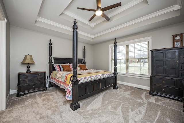 carpeted bedroom with crown molding, ceiling fan, and a tray ceiling