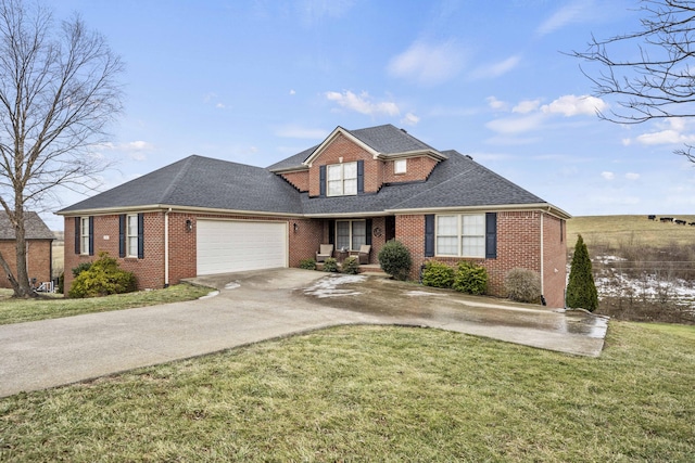 view of front of house with a garage and a front yard