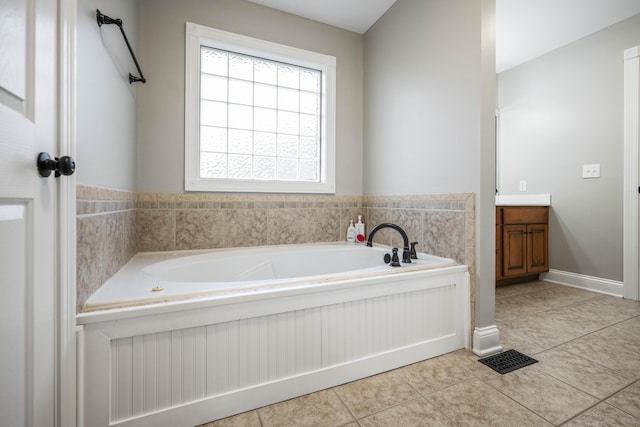 bathroom with vanity, tile patterned flooring, and a tub