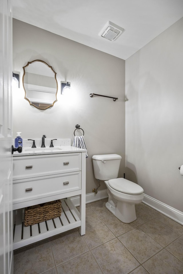 bathroom with tile patterned flooring, vanity, and toilet