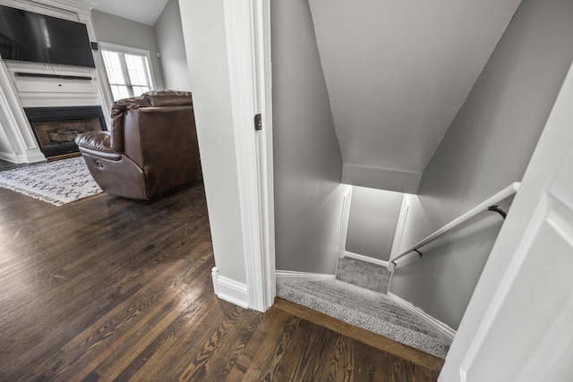 stairs featuring vaulted ceiling and hardwood / wood-style floors