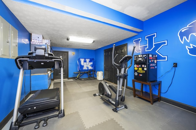 exercise room with a textured ceiling