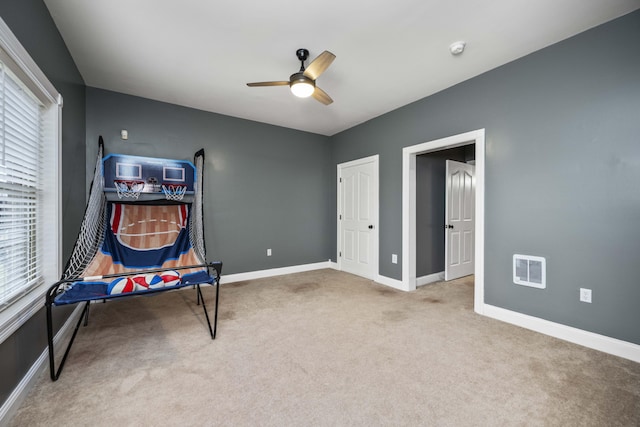 recreation room with carpet and ceiling fan