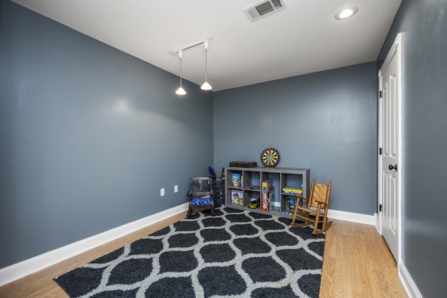 game room with wood-type flooring