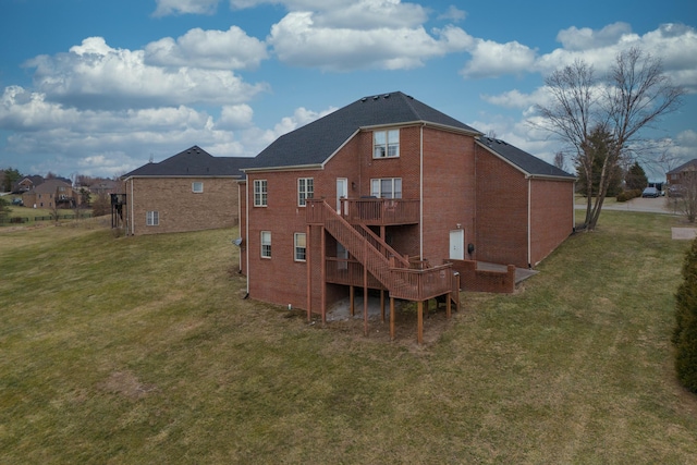 back of property featuring a wooden deck and a lawn