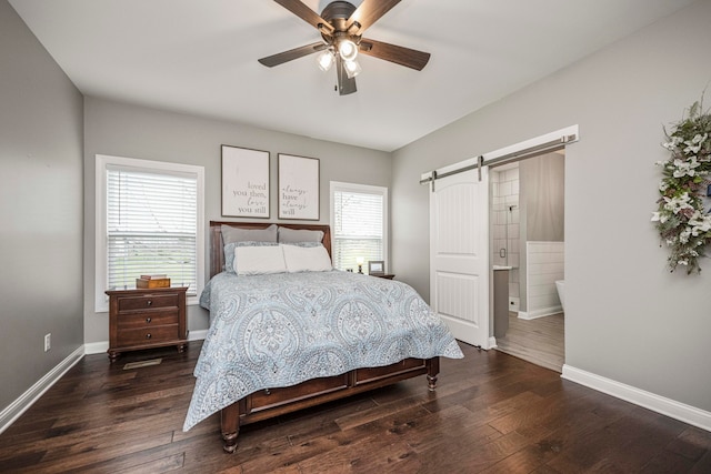 bedroom with ceiling fan, a barn door, dark hardwood / wood-style flooring, and multiple windows