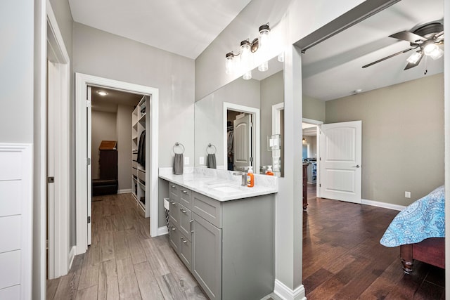 bathroom with hardwood / wood-style flooring, vanity, and ceiling fan