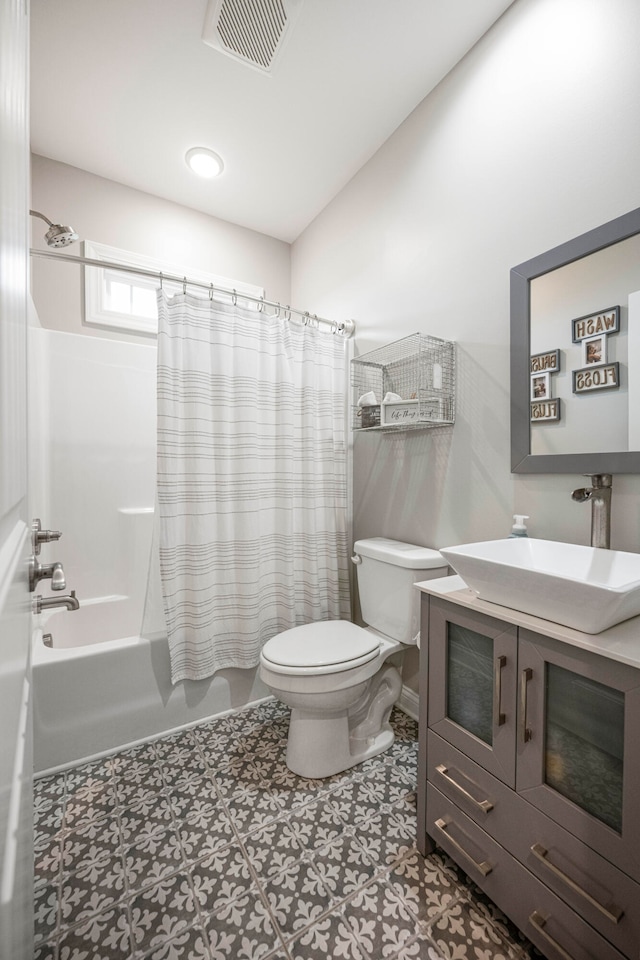 full bathroom featuring tile patterned floors, vanity, toilet, and shower / tub combo with curtain