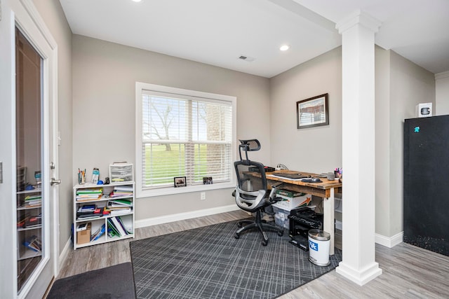 office area featuring hardwood / wood-style flooring and decorative columns