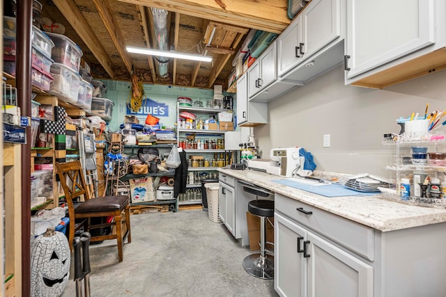 kitchen featuring stainless steel dishwasher and light stone counters