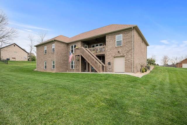 back of house with a yard, a deck, and a garage