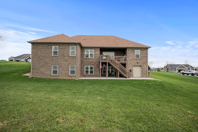 rear view of house featuring a lawn, a deck, and a garage