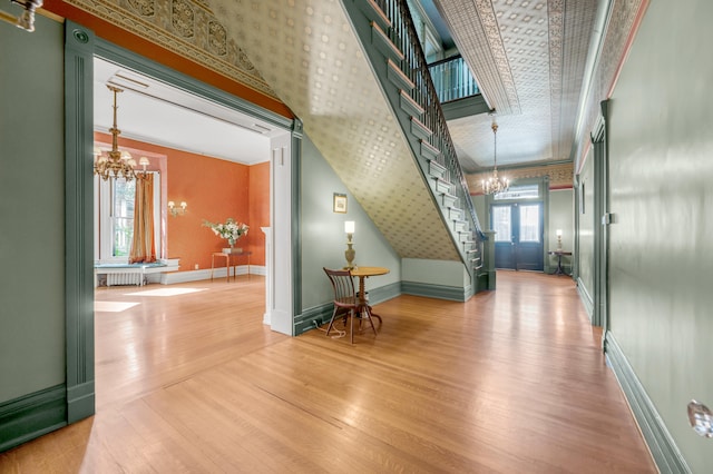 interior space featuring french doors, hardwood / wood-style flooring, a wealth of natural light, and crown molding