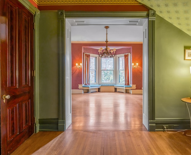 hallway with a chandelier and wood-type flooring