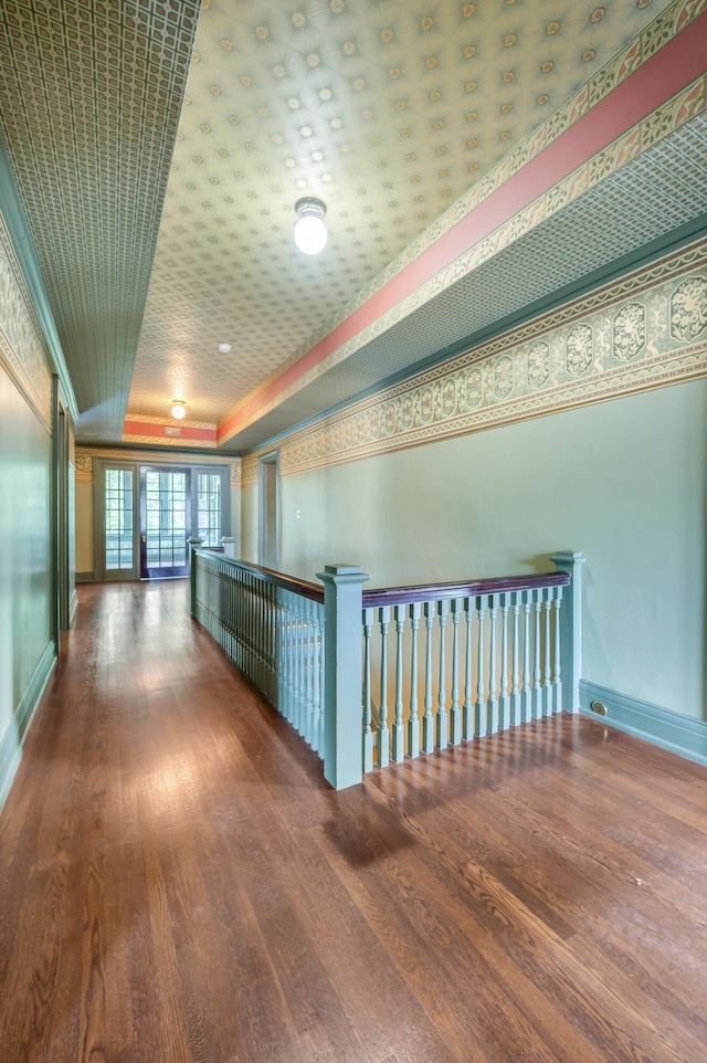 corridor with crown molding and dark wood-type flooring