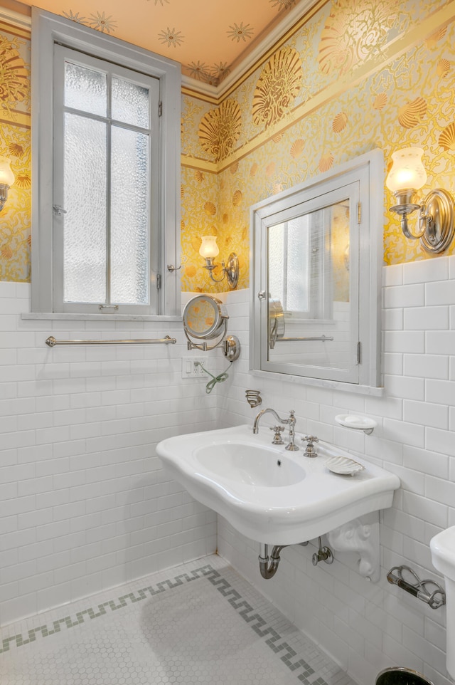 bathroom featuring sink, tile patterned floors, plenty of natural light, and tile walls