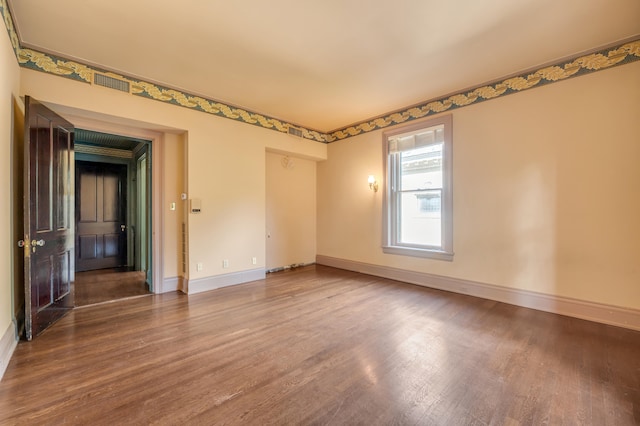 empty room with wood-type flooring