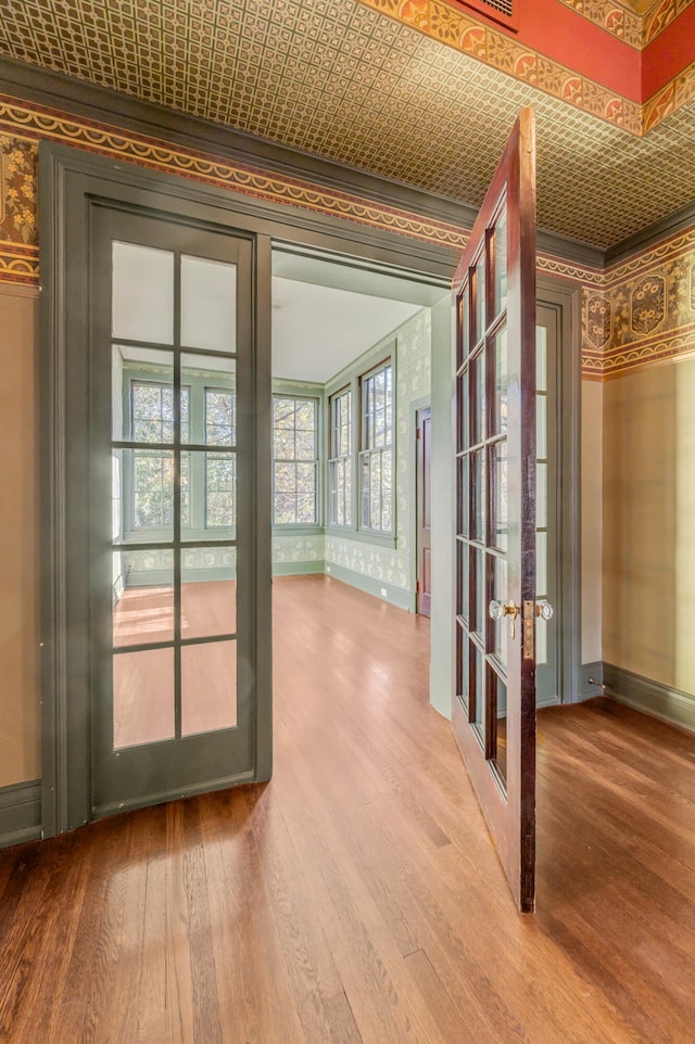 doorway to outside with hardwood / wood-style floors, french doors, and ornamental molding