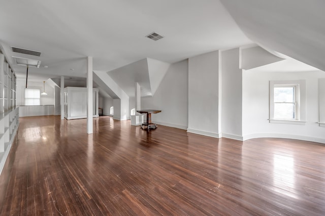 additional living space featuring lofted ceiling and dark wood-type flooring