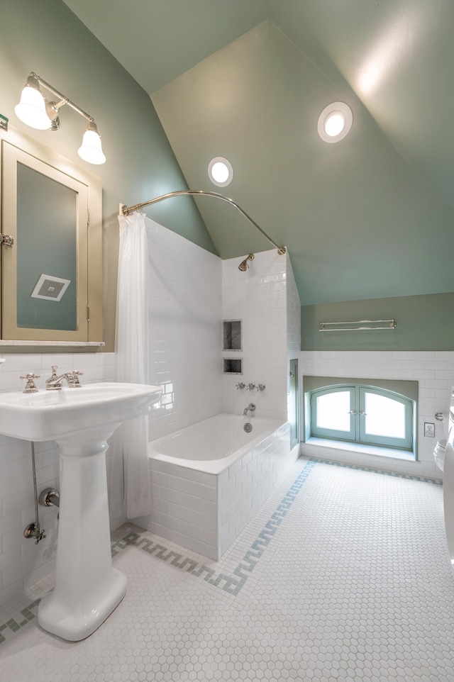 bathroom featuring tile patterned floors, shower / bathtub combination with curtain, and lofted ceiling