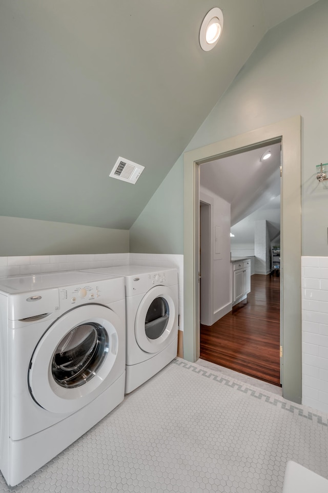 washroom featuring hardwood / wood-style flooring and washer and clothes dryer