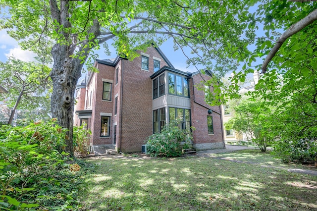 view of property exterior with a yard