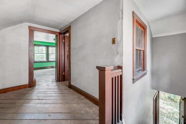 corridor featuring hardwood / wood-style floors and vaulted ceiling