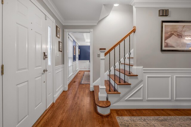 foyer featuring crown molding and wood-type flooring