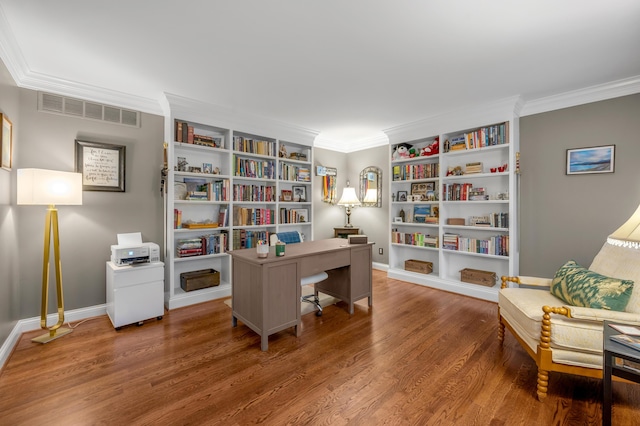 home office featuring crown molding, hardwood / wood-style floors, and built in shelves