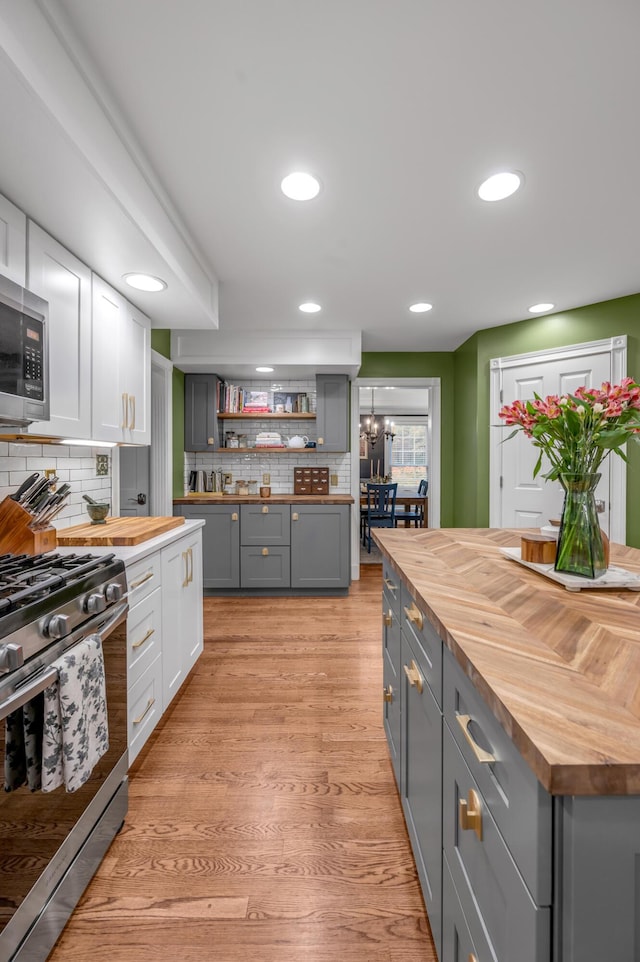 kitchen with white cabinetry, butcher block countertops, gray cabinets, and stainless steel appliances