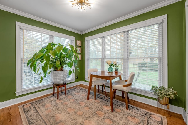 interior space with wood-type flooring and ornamental molding