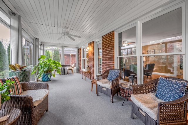 sunroom / solarium featuring ceiling fan