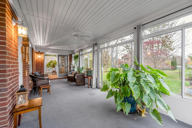 sunroom featuring ceiling fan