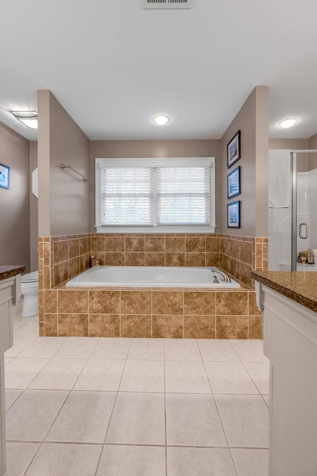 bathroom with vanity, toilet, a shower with door, and tile patterned flooring