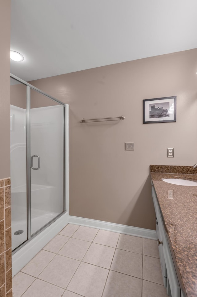 bathroom featuring vanity, a shower with door, and tile patterned floors