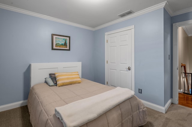 bedroom with ornamental molding and carpet floors