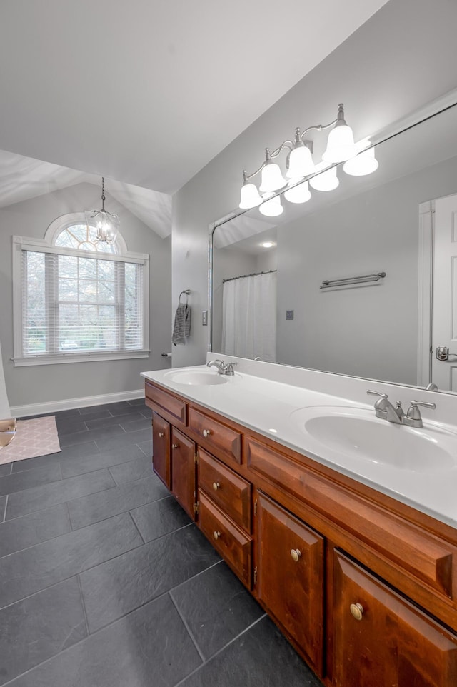 bathroom featuring vanity, tile patterned flooring, vaulted ceiling, and a chandelier