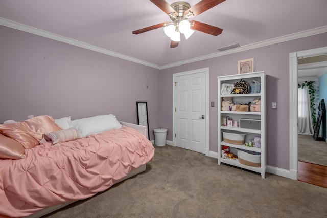 bedroom with ornamental molding, light colored carpet, and ceiling fan