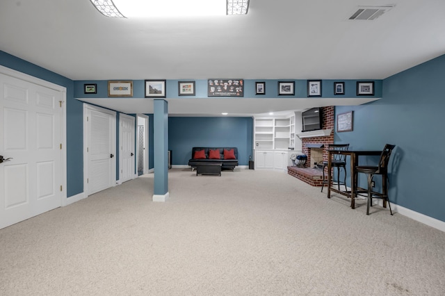 interior space with a brick fireplace and carpet floors