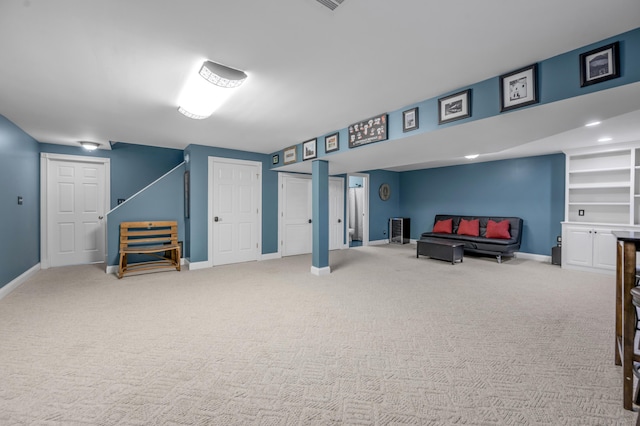 basement with built in shelves and carpet flooring