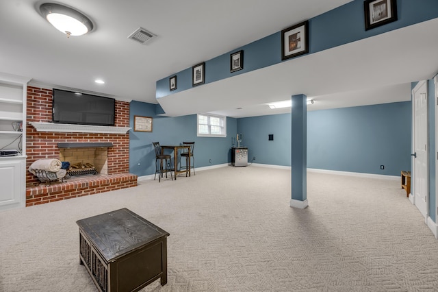 basement featuring light colored carpet and a fireplace