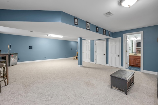 basement with light colored carpet and sink