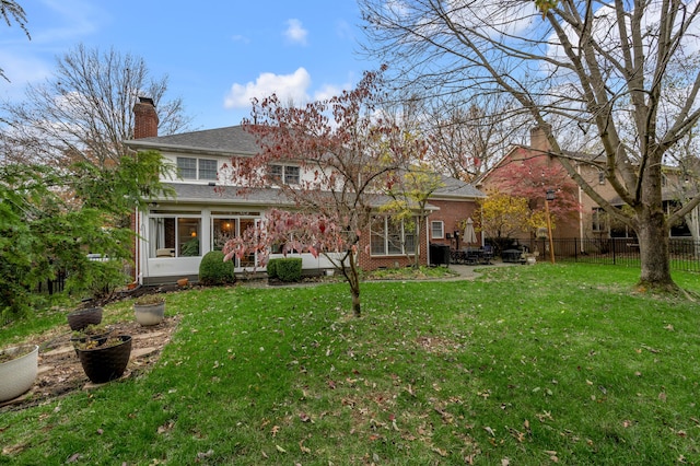 rear view of property featuring a yard