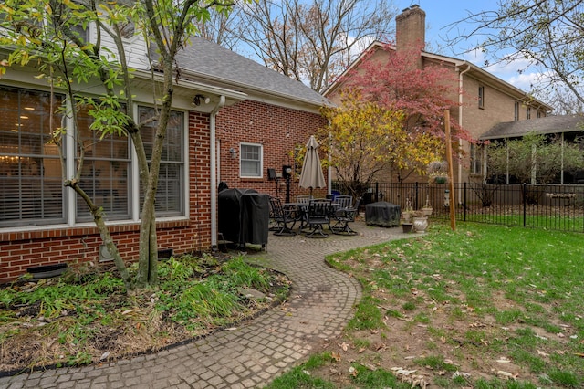 back of house featuring a yard and a patio