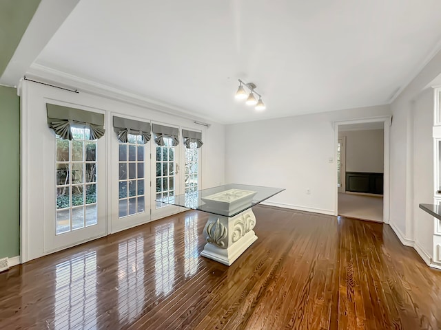 interior space with crown molding and dark hardwood / wood-style flooring